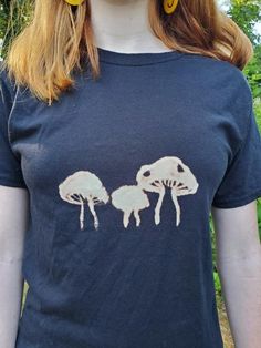 A mushroom that I hand painted with bleach onto a black t-shirt. Bleach Painting, Bleach Water, Mushroom Shirt, Paint Shirts, Craft Night, Clothing Hacks, Black T Shirt, Printed Tees, Celery