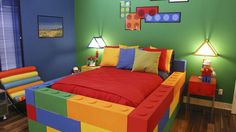 a bedroom decorated in bright colors with legos on the bed and side tables next to it