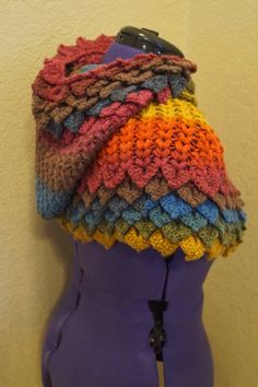 a mannequin wearing a multicolored knitted hat on it's head