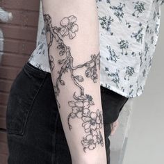 a woman with a flower tattoo on her arm