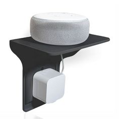 an image of a wall mounted speaker on the side of a shelf with a plugged in outlet