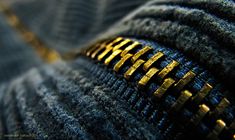 the zippers on a pair of jeans are gold - plated and stitched