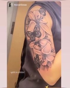 a woman's arm with flowers and butterflies on it