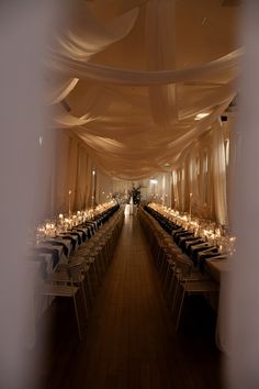 a long table is set up with black and white linens for an elegant dinner