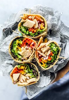 four wraps filled with chicken, lettuce and vegetables