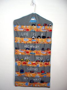 a wall hanging with cars on it and the words life is highway are you going my way?