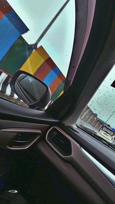 a car's view from inside the vehicle with colorful umbrellas in the background