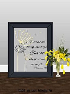 a vase filled with yellow flowers sitting on top of a table next to a framed photo