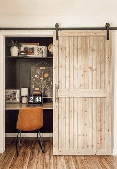 an office with a desk and wooden doors