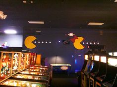 several arcade machines lined up in a room