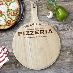 a pizza on a cutting board next to a plate with pepperoni and jalapenos