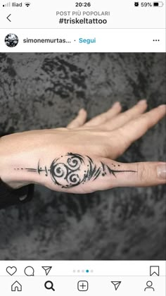 a person's hand with a tattoo on it