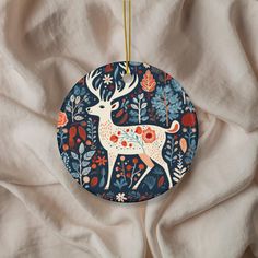 an ornament with a deer and flowers on it