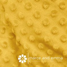 an image of a yellow blanket with small dots on it and the words marc and emma written in white