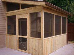 a screened in porch with windows on the side