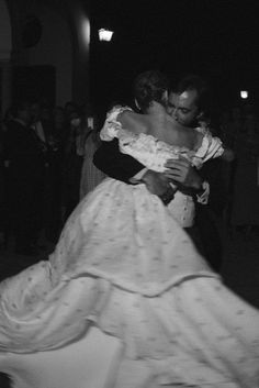 black and white photo of bride and groom dancing