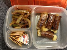 two plastic containers filled with food on top of a table