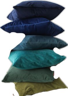 four pillows stacked on top of each other in different colors and sizes, with the same pillow