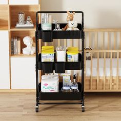 a baby crib with various items on it and a teddy bear in the background