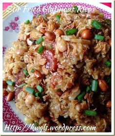 rice with nuts and green onions on a plate