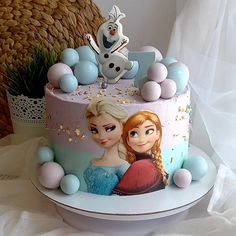 there is a cake decorated with frozen princesses