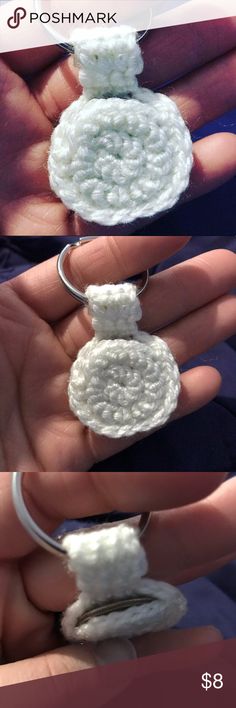 crochet rings are being held in the palm of someone's left hand