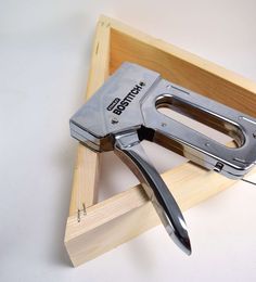 a pair of pliers sitting on top of a wooden box