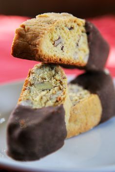 two chocolate covered cookies stacked on top of each other with one bite taken out of it