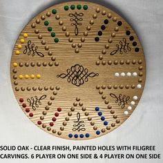 a wooden board game with many different colored dots and lines on it, along with the words sold oak - clear finish, painted holes with