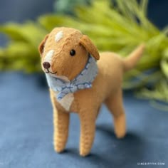 a small stuffed dog with a blue bow tie