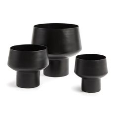 three black vases sitting next to each other