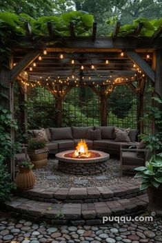 an outdoor fire pit surrounded by greenery