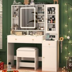 a white dressing table with a mirror, stool and christmas lights on the wall behind it