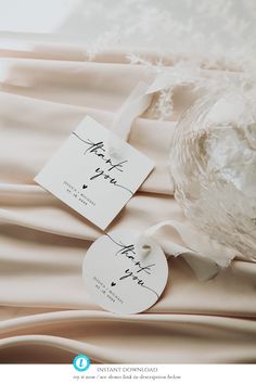 two tags are attached to the back of a wedding dress