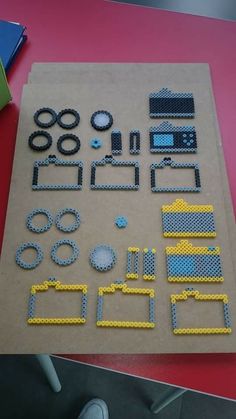 some lego parts are laying out on a table with a person standing next to them