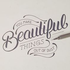 a pen is sitting on top of a piece of paper that says, you make beautiful things out of dust