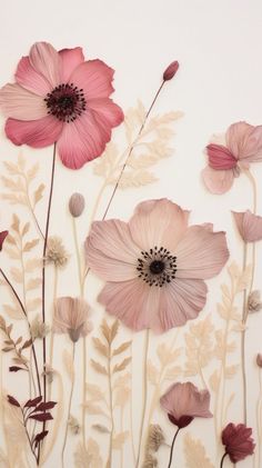 some pink flowers on a white wall and one is in the middle of it's frame