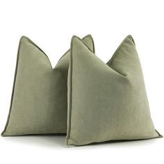 two green pillows sitting on top of each other