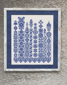 a blue and white framed artwork on the wall