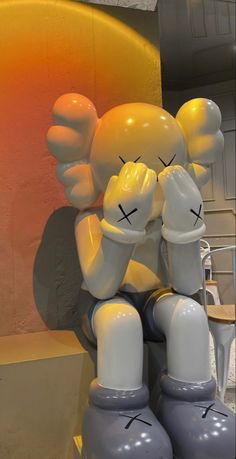 an inflatable toy sitting on top of a table next to a yellow chair