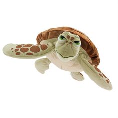 a stuffed turtle is in the air with it's head tilted to the side