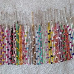 several rows of beaded bracelets lined up on a towel