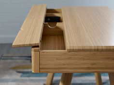 a wooden desk with an open drawer on it