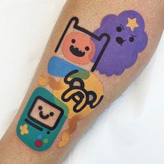 a person with some tattoos on their legs and one has an image of two cartoon characters