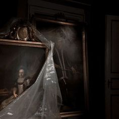 a black and white photo of a woman in a dress with a veil on her head