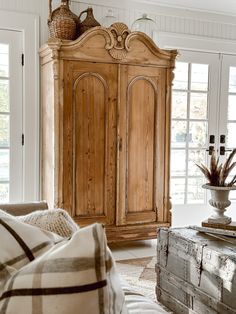 a large wooden armoire in a living room