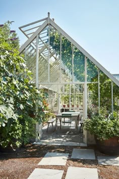 a glass house with potted plants inside