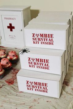 three boxes that have some cupcakes in them on a table with blood all over the floor