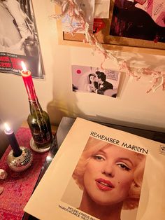 a table topped with a magazine and a candle