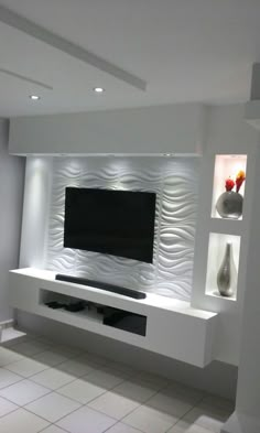 a large flat screen tv mounted to the side of a wall in a living room